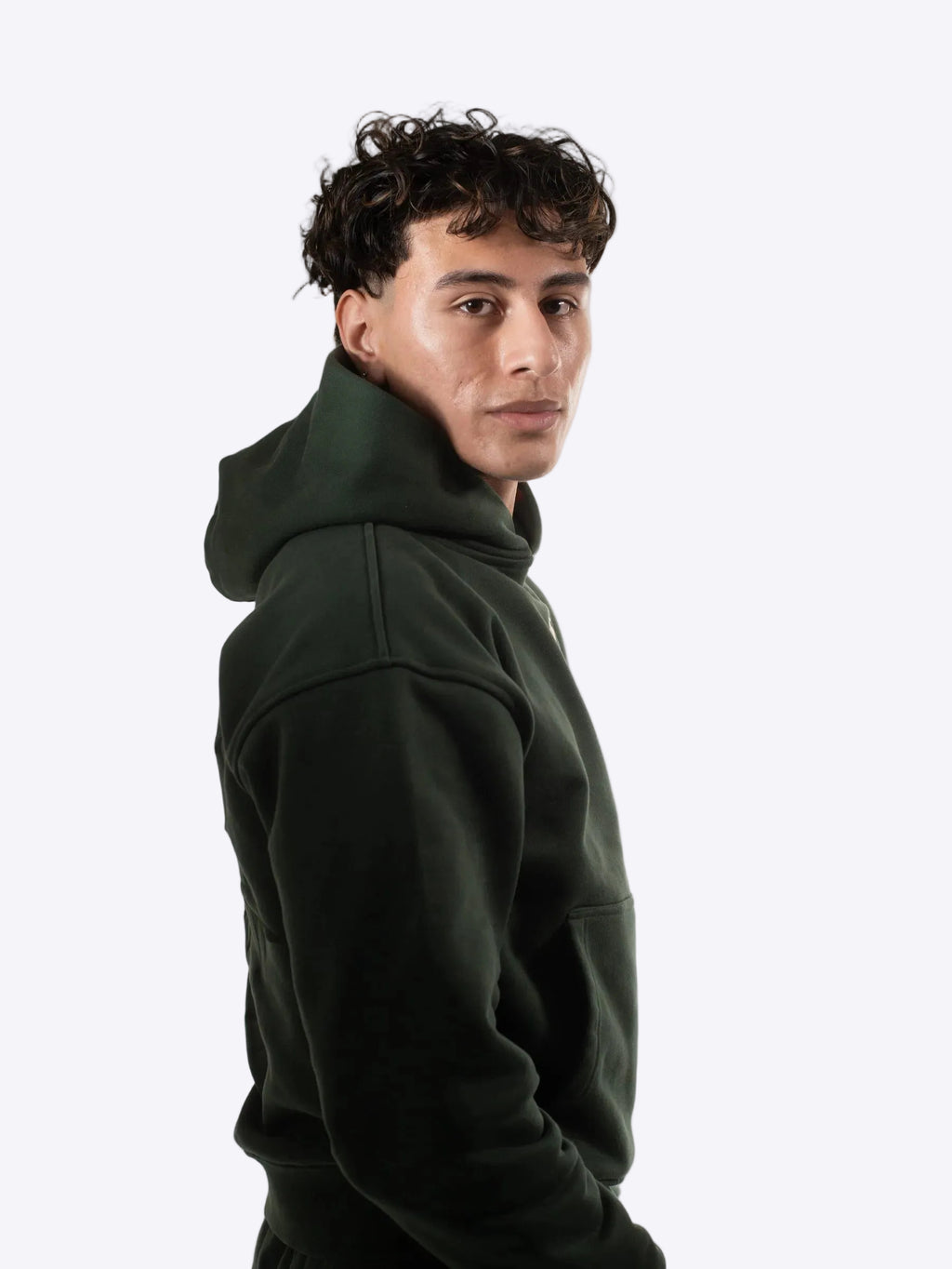 Person wearing a cherrytop dark green hoodie against a plain background