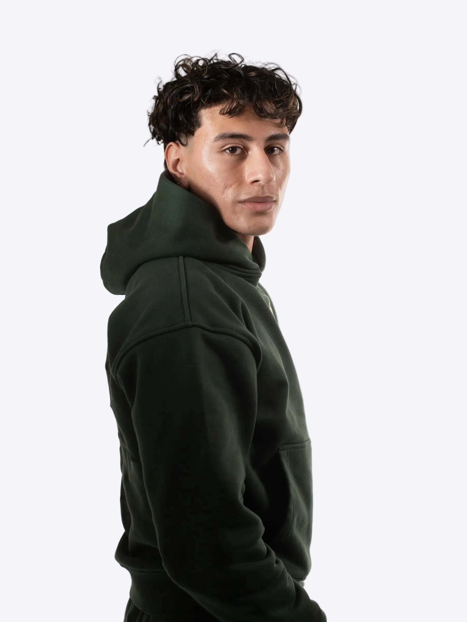 Person wearing a cherrytop dark green hoodie against a plain background